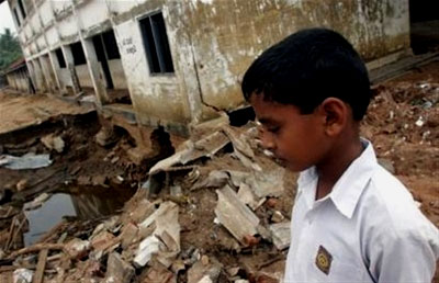 A young boy walks amid the destruction