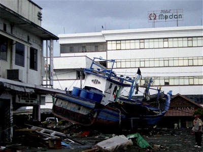 A destroyed boat that was thrown on land by the tsunami