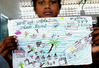 A young girl holds her drawing of the tsunami