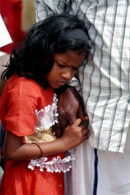 A girl holds her father's hand