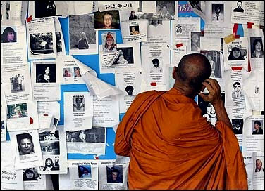 A buddhist monk views missing people notices