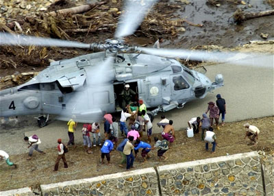U.S. Navy personnel deliver aid