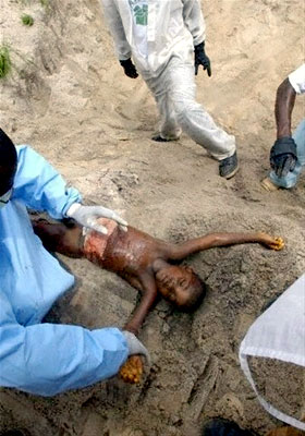 A dead boy is blessed before he is buried