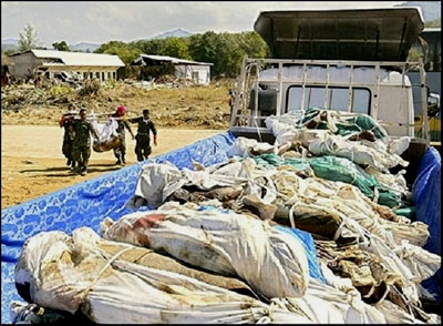 Workers move the dead to the morgue