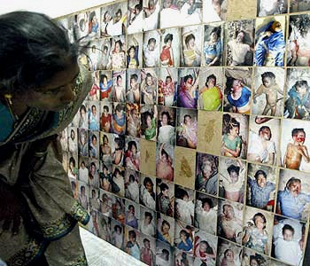A woman searches for a relative among the
pictures of those who passed away in the tsuanmi