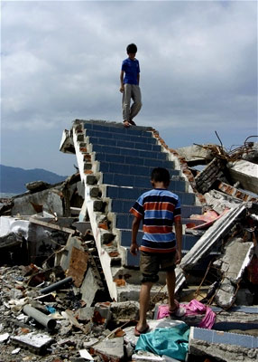 Stairs to nowhere -- Two boys walk on a staircase
next to a destroyed building