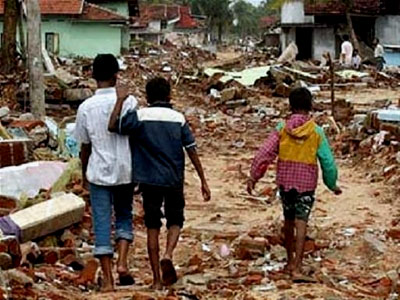 Three boys walk through the destruction