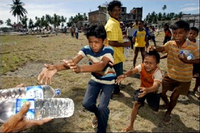 Children run to get some bottles of water