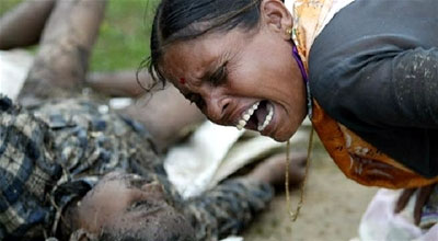 A woman screams in grief as she mourns the loss of her child