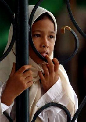 A young girl views the destruction